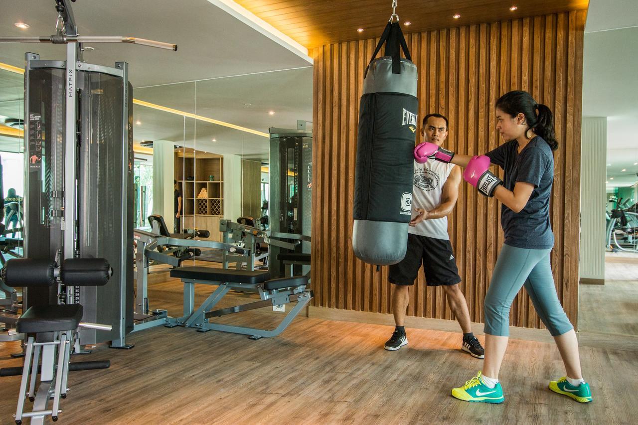 Fusion Suites Phuket Patong Kültér fotó A woman training with a personal trainer